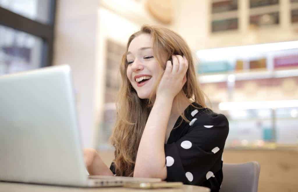 woman working on laptop to get paid to be an online friend