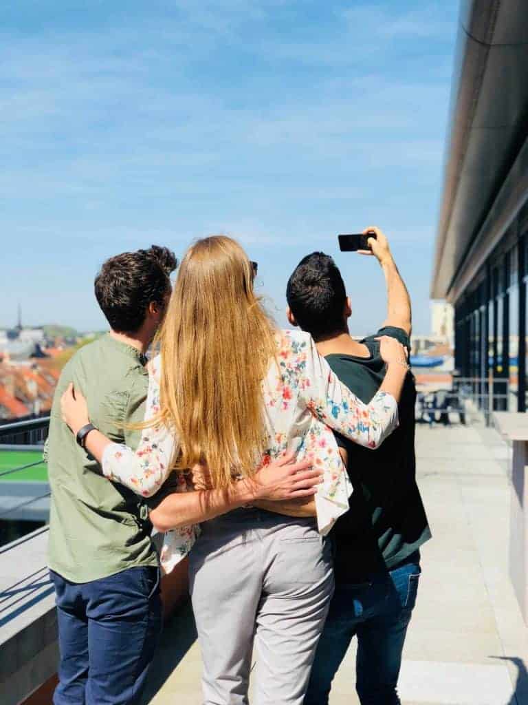 three people taking a selfie