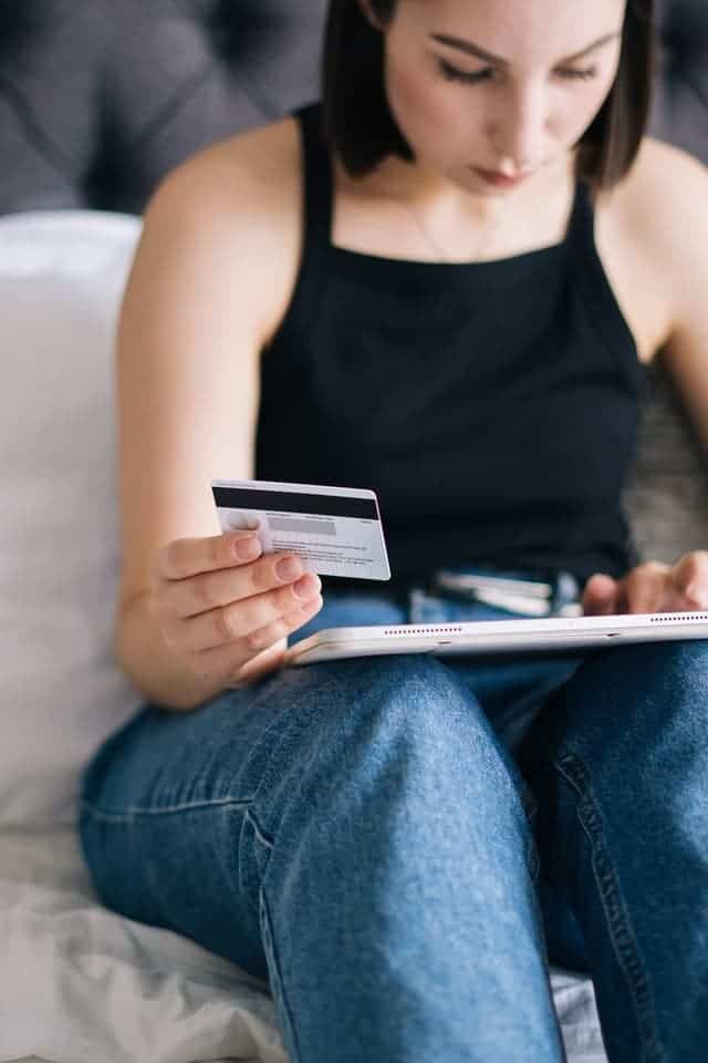 woman buying something online to turn Visa gift cards into cash