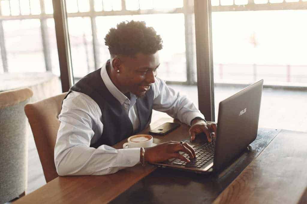 man working on laptop to get paid to talk to lonely women