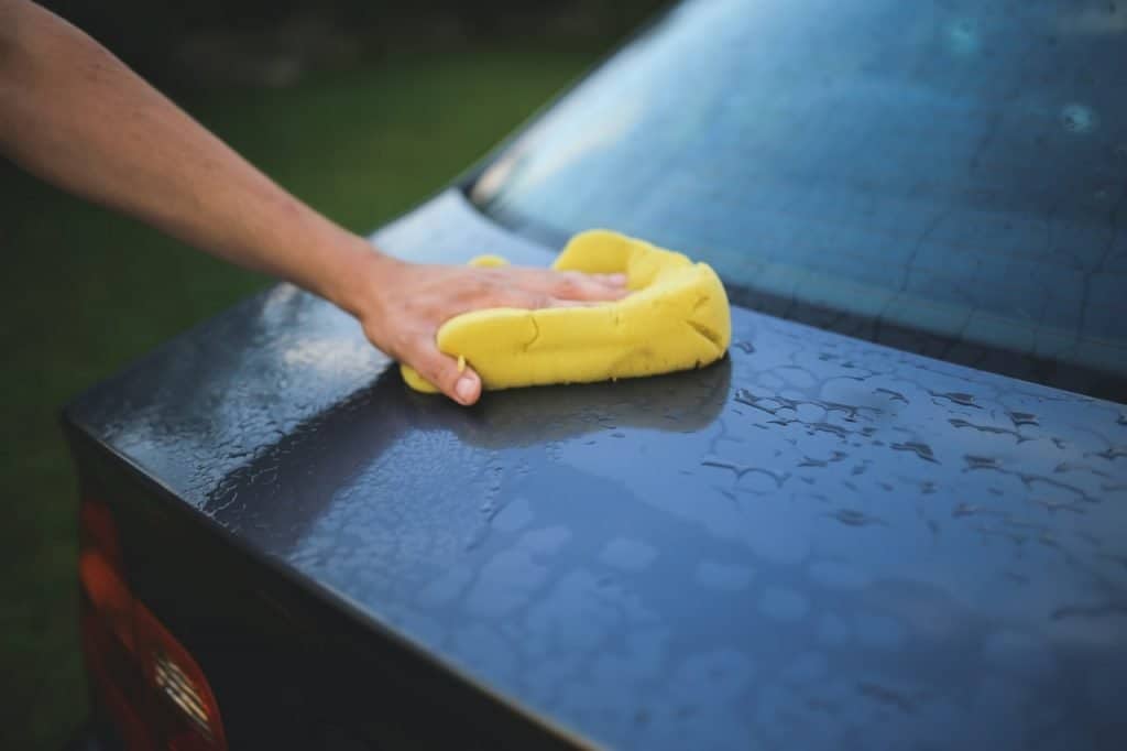person washing a car for their cash paying job