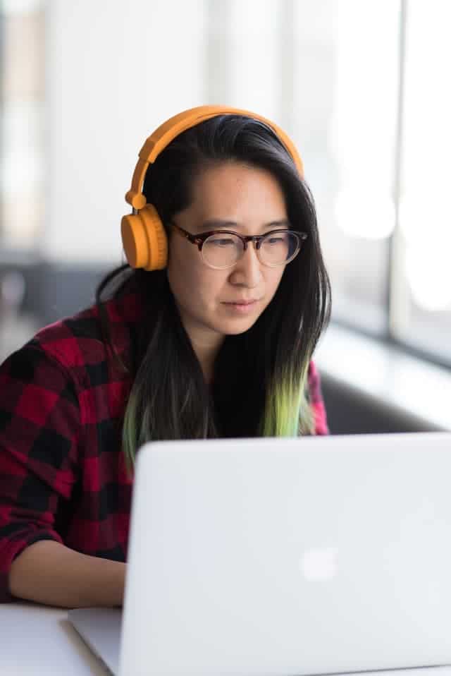 woman with headphones on laptop