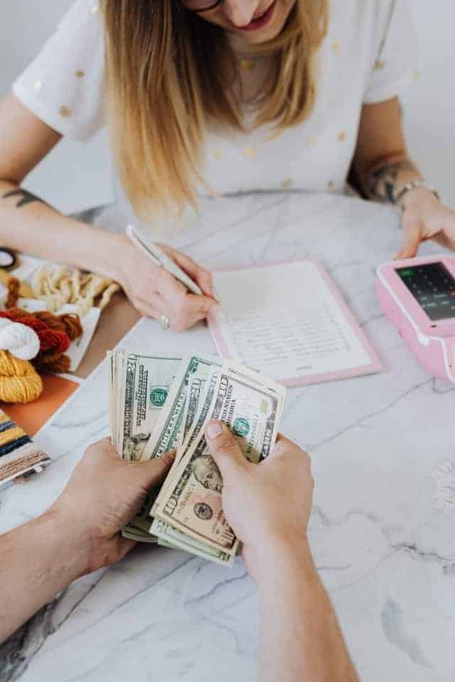 woman budgeting after seeing the benefits of why you should save money
