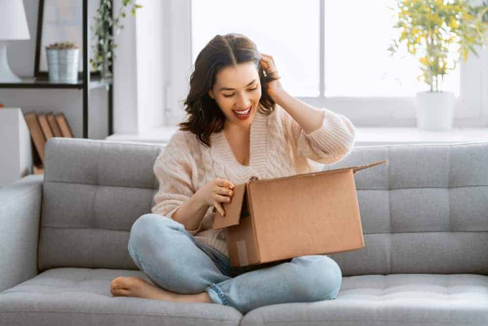 woman receiving package after working out How to Get Companies to Send You Products to Review