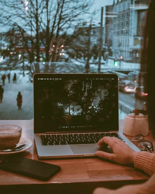 person on laptop with view behind them