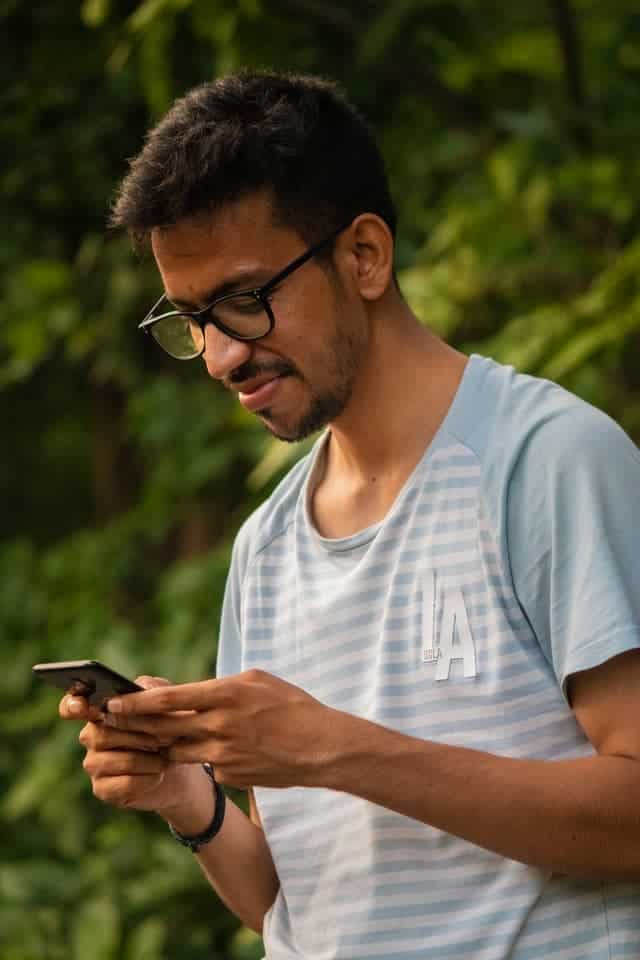 man using cell phone to get paid to text