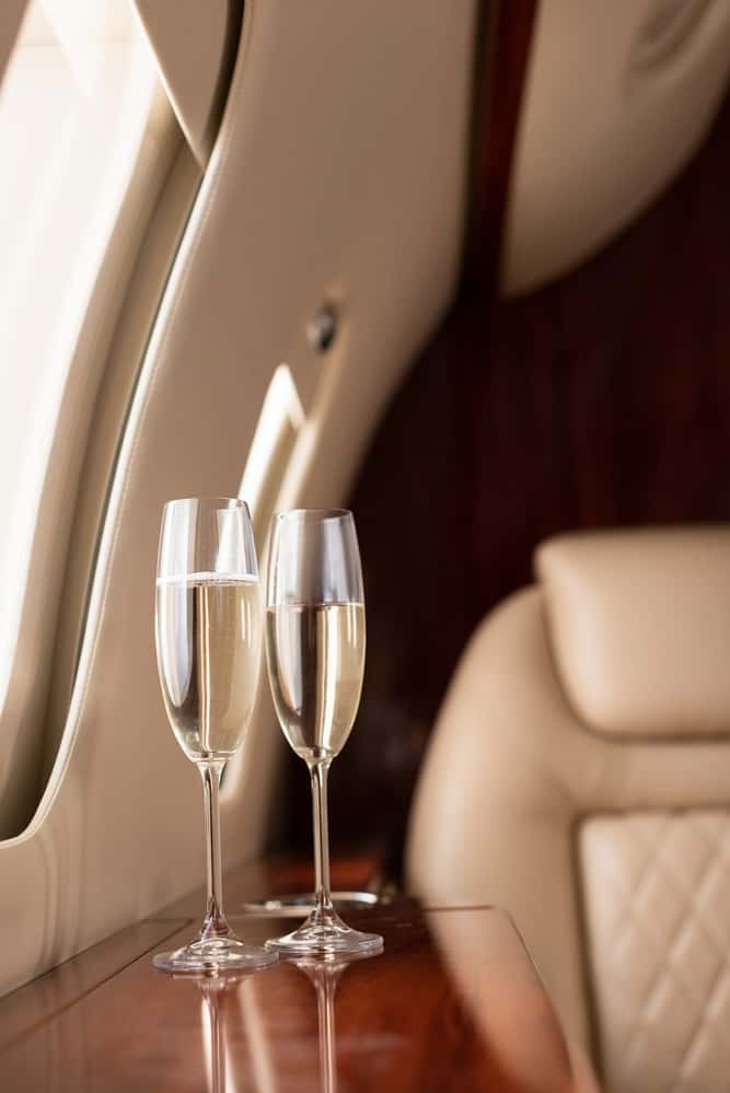 champagne on a private jet for someone earning 8 figures in money