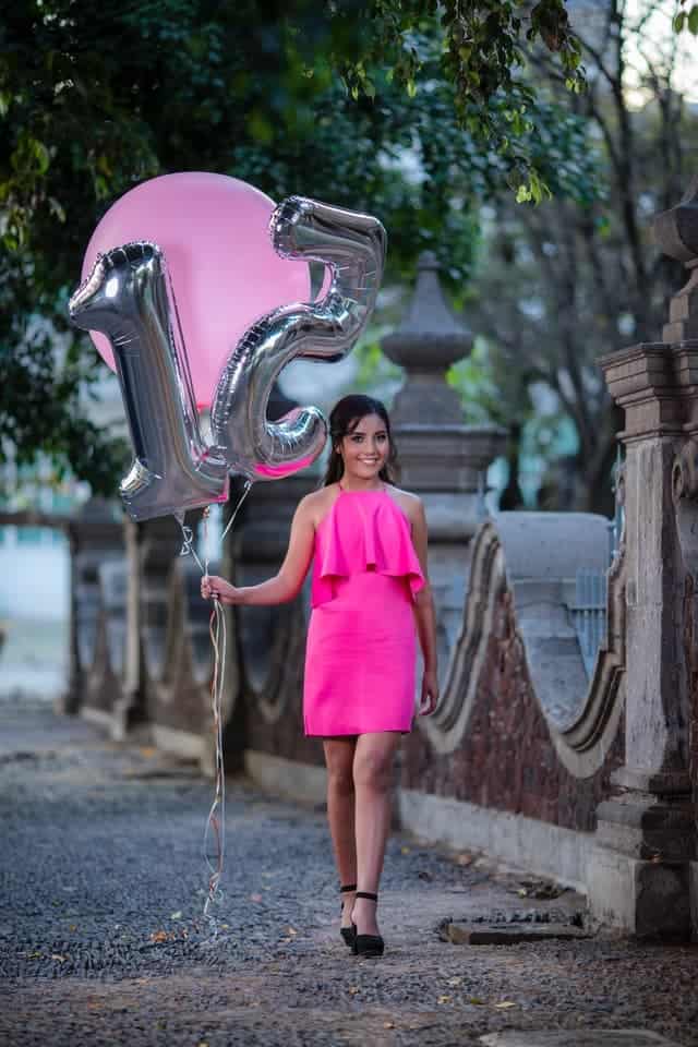 girl with balloons in number 15 for her cheap quinceanera on a budget