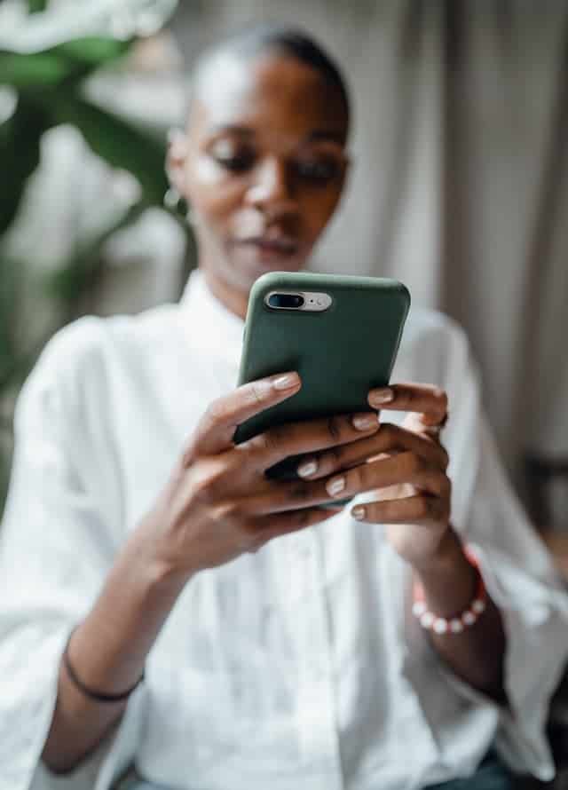 woman on her phone trying to get free gift cards fast