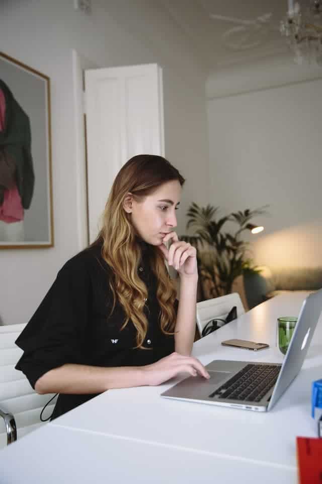 woman working on laptop looking for how do freelance writers get work