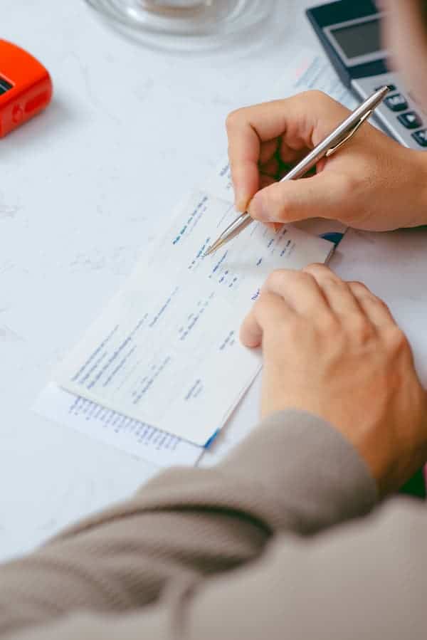 person writing certified check