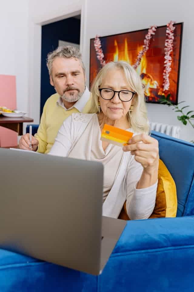 couple on laptop working out how to use an expired debit card