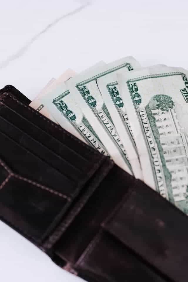 $20 dollar bills in a wallet as an example of money made of cotton and linen