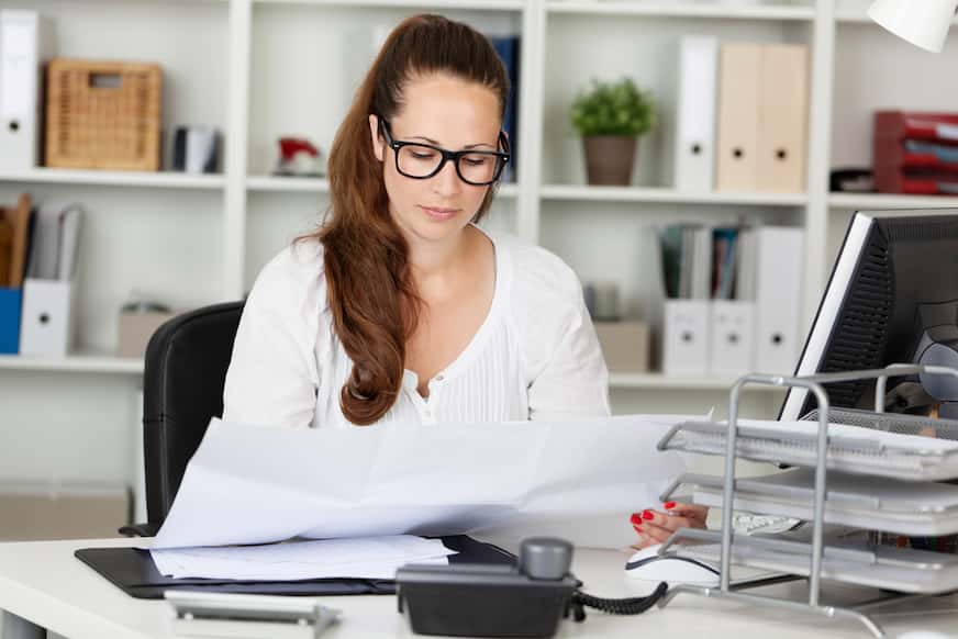 woman reading a document to find out what is a good salary for a single person