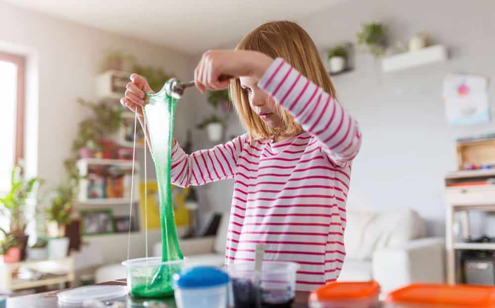 girl making slime as one of the best Etsy shop ideas for 12 year olds and younger