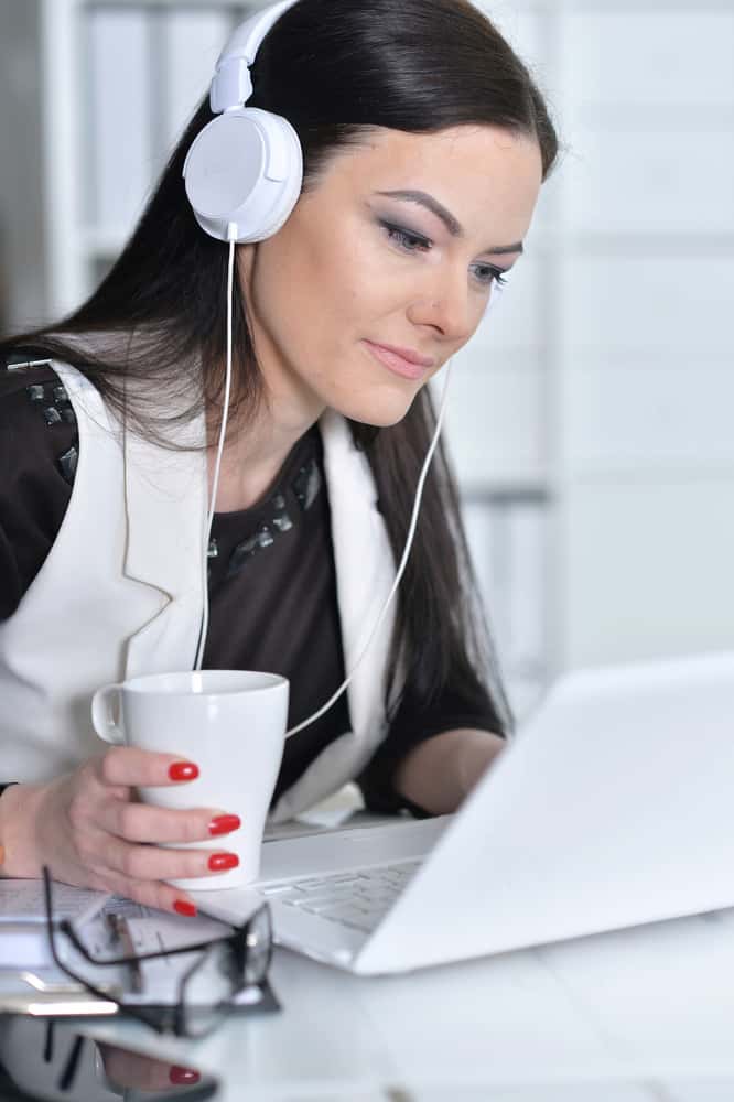 a woman on her headphone get paid to listen to music