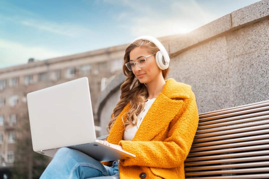 a woman on her laptop doing affiliate marketing to make money on audible