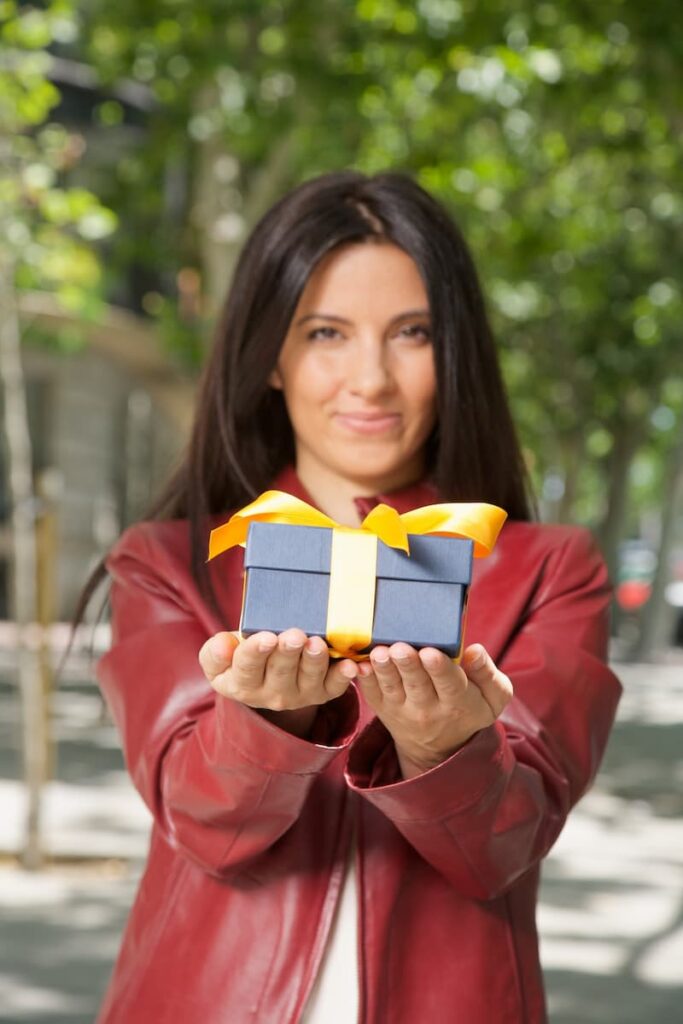 a woman holding a high school graduation gift