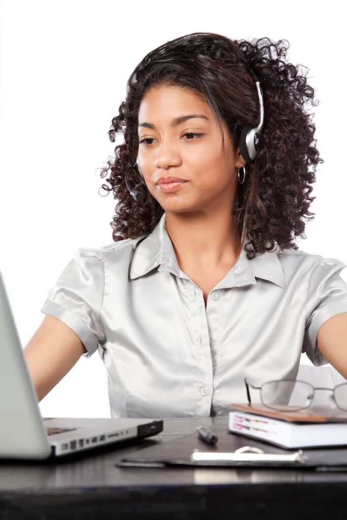 a woman with headphone and laptop working on one of the best transcription jobs from home with no experience