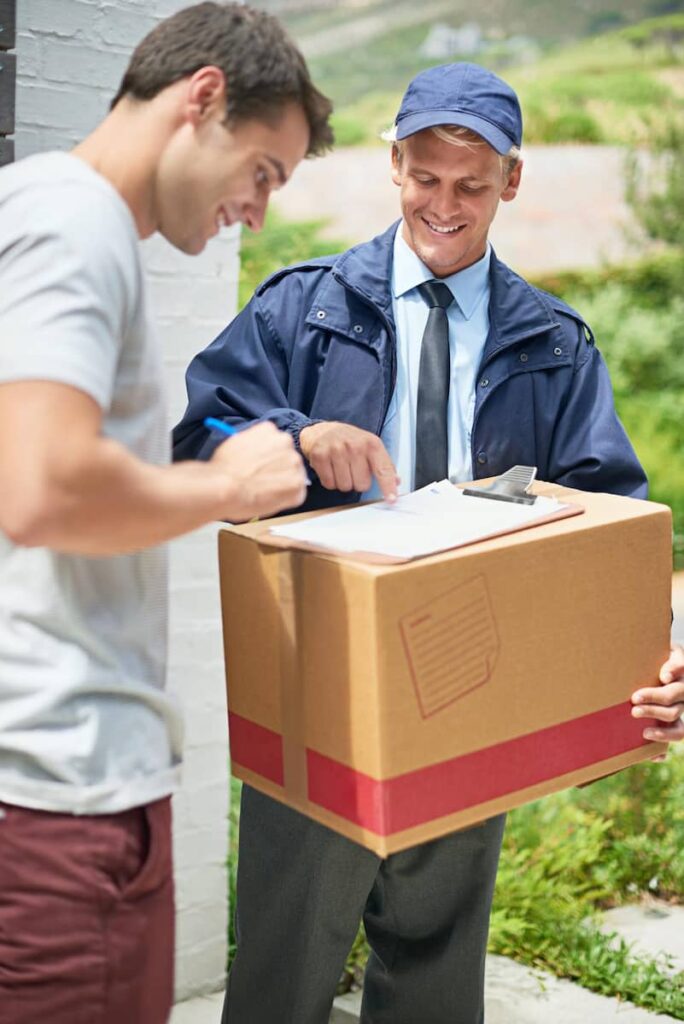 a delivery man holding a package with a customer signing a document