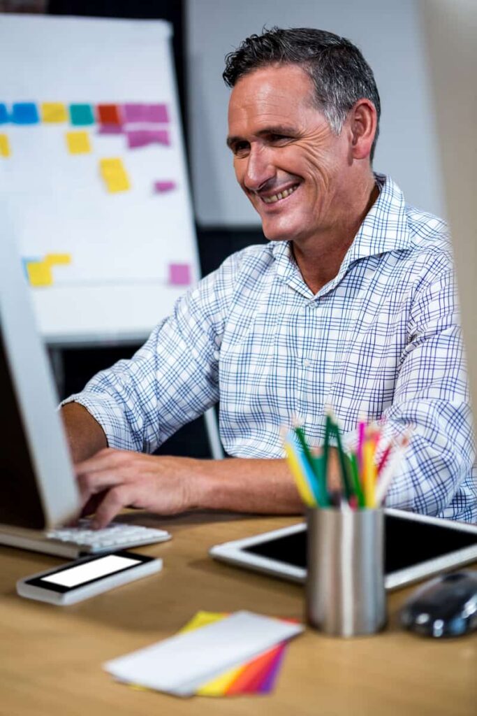 a man working on his computer to make digital products to sell on Etsy