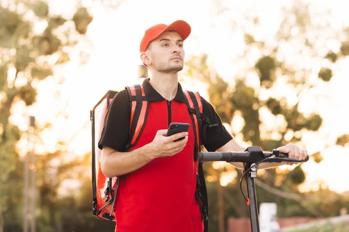 A man working as a DoorDash delivery driver