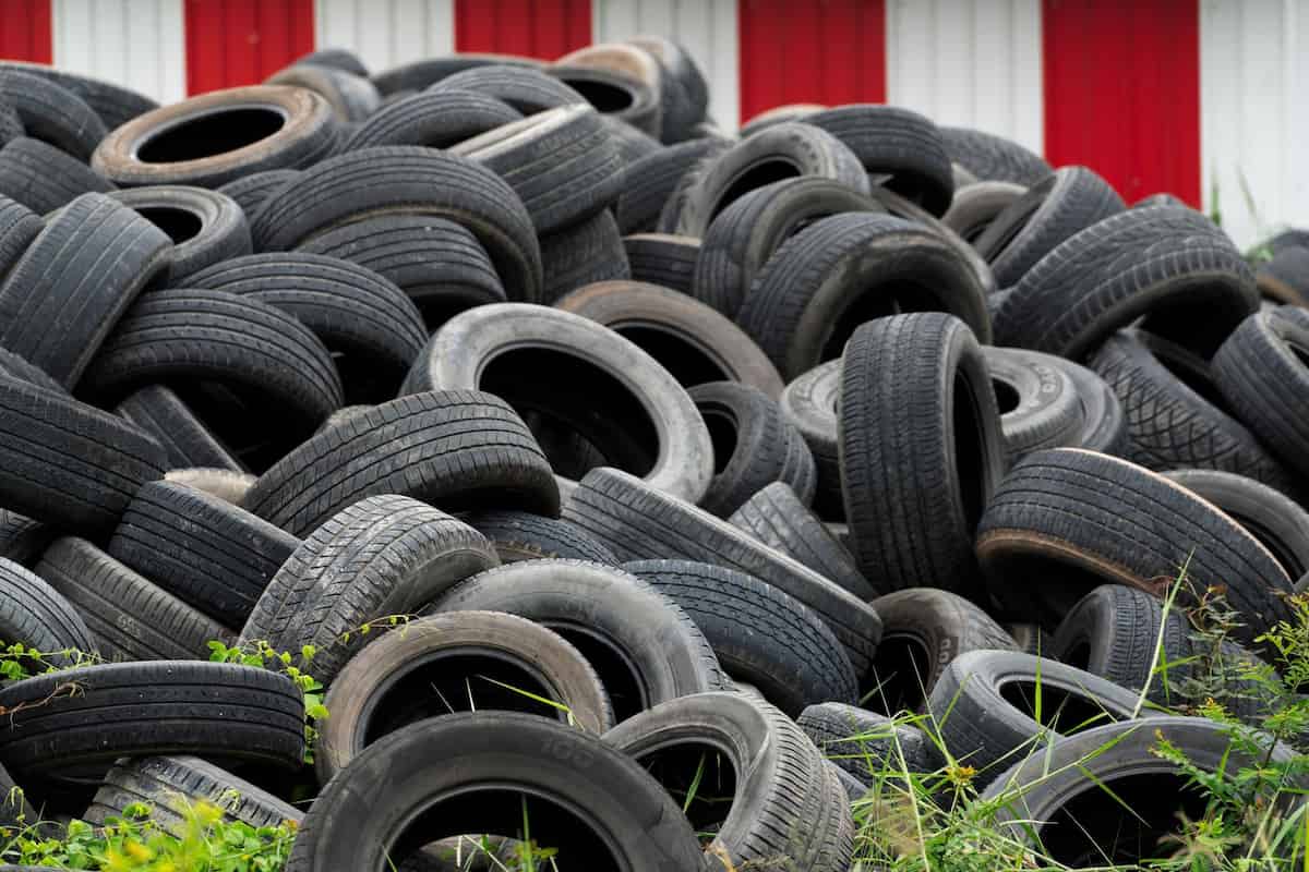 pile of used tires in a recycling center that sell used tires