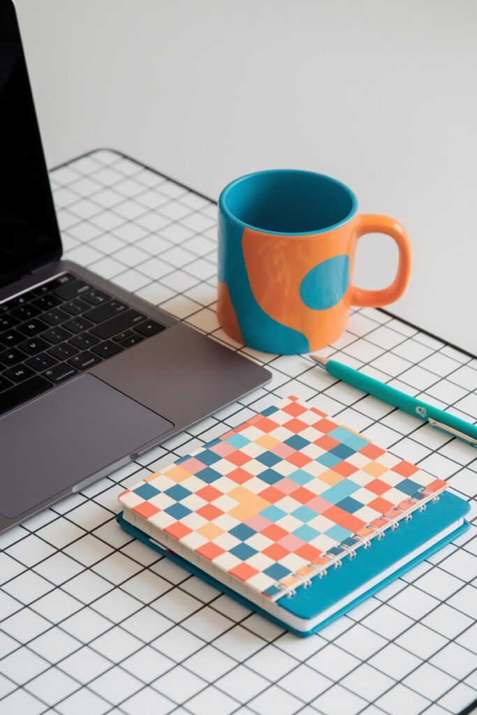 Flatlay of laptop, coffee, notebook, and pen - 35 Ultimate Hacks to Save $5,000 in 6 Months (That Actually Work)