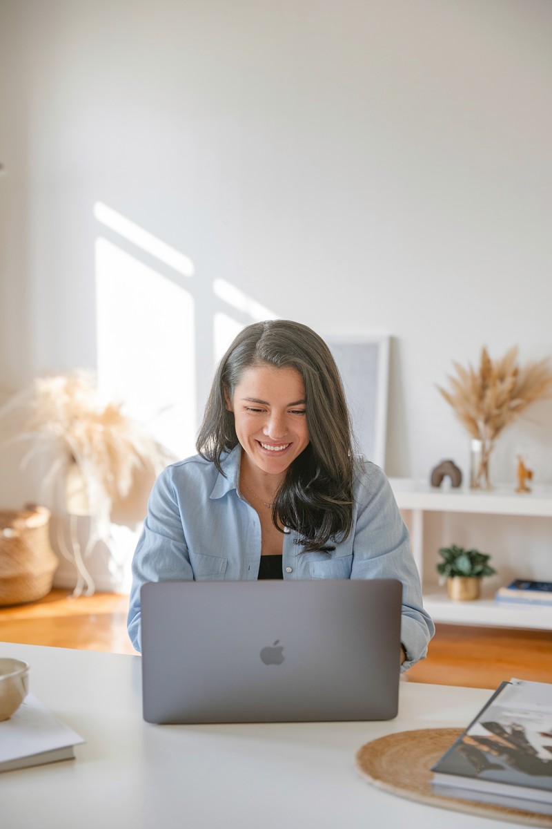a woman with laptop in naturally-lit home for selling on Etsy