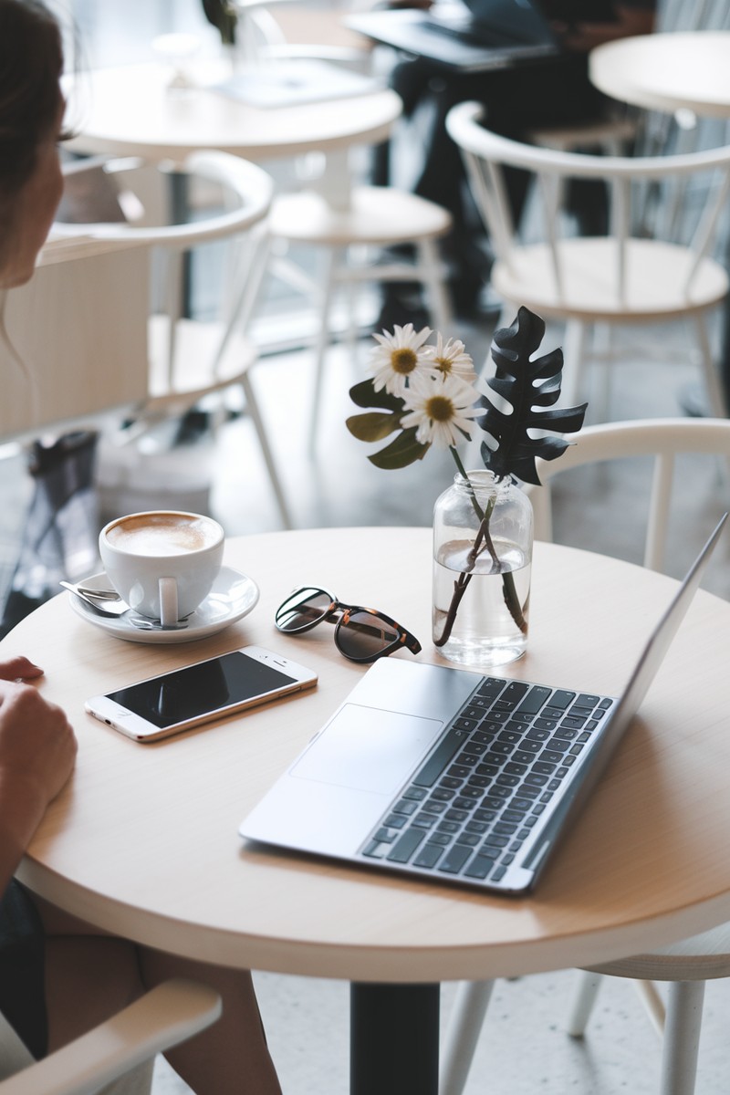 woman working at a cafe table