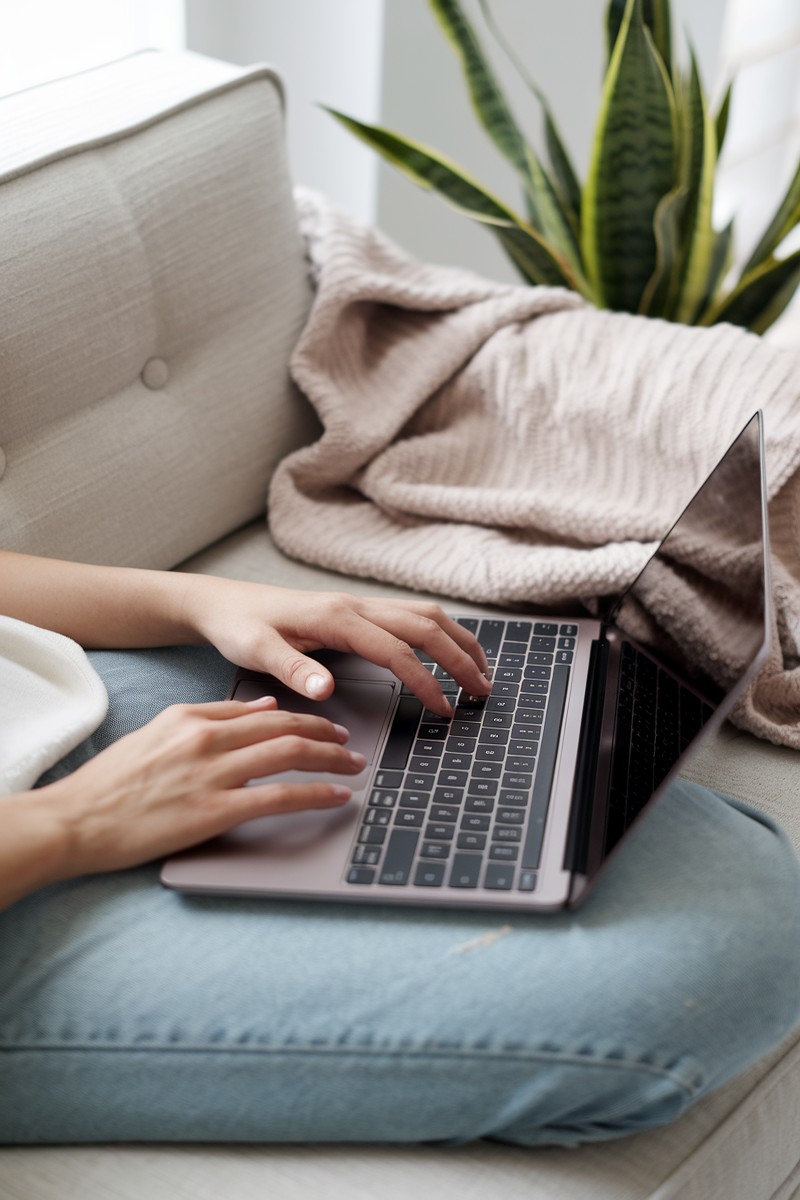 person using a laptop in a bright living room