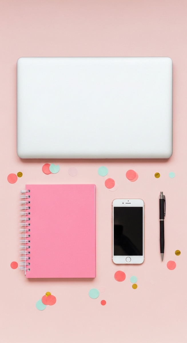 a pink flatlay with laptop, notebook, and phone to make $2,000