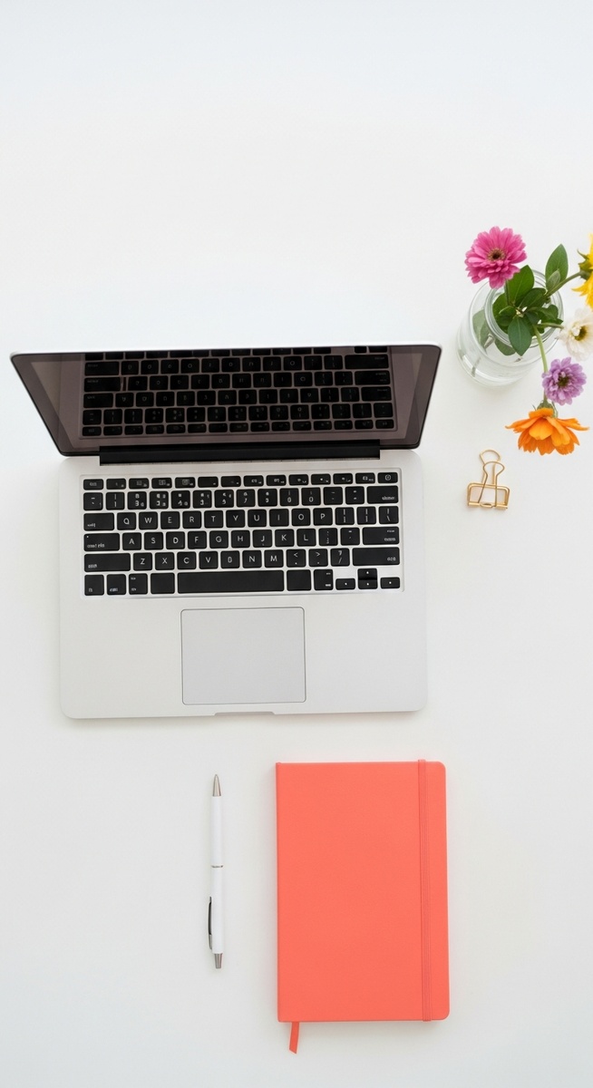 flatlay with laptop and other items on a white surface
