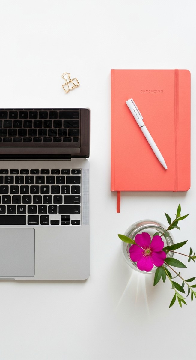 flatlay with laptop and other items on a white surface