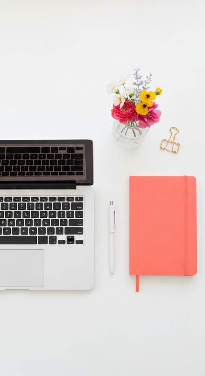 flatlay with laptop and other items on a white surface