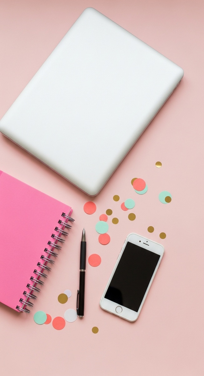 a pink flatlay with laptop, notebook, and phone for selling on Etsy