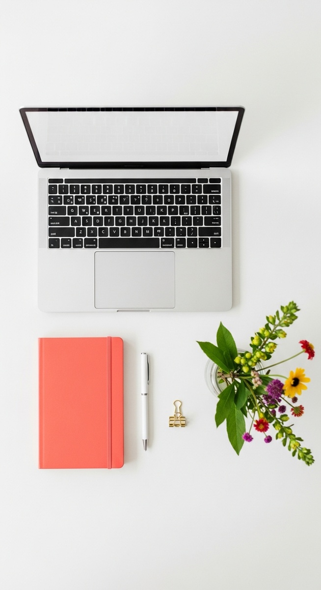 flatlay with laptop and other items on a white surface