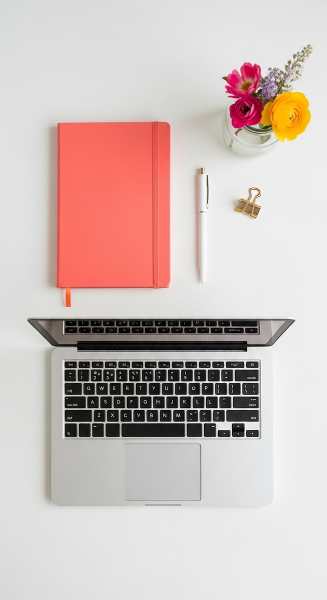 flatlay with laptop and other items on a white surface