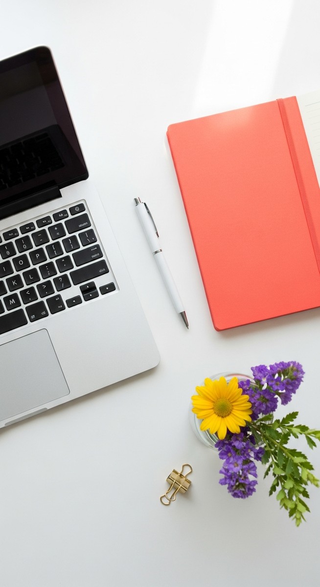 flatlay with laptop and other items on a white surface