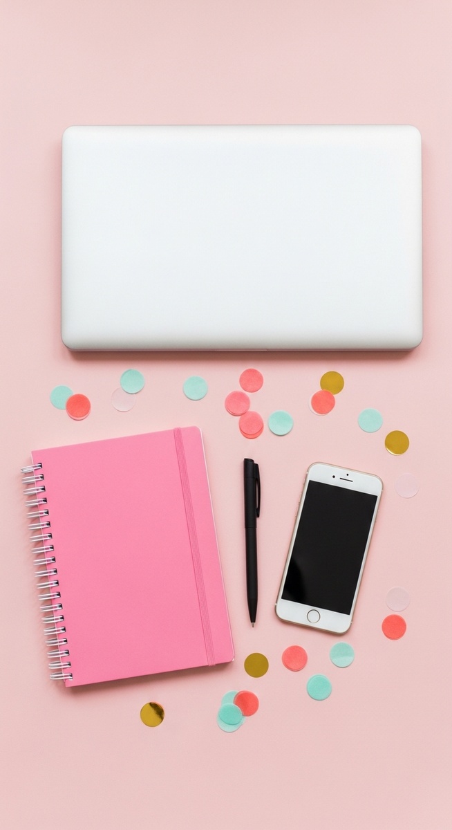 a pink flatlay with laptop, notebook, and phone for virtual assistant work