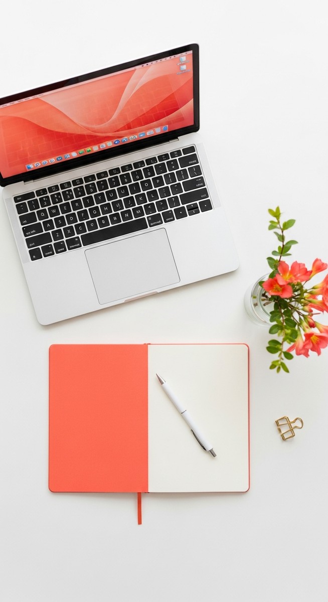 flatlay with laptop and other items on a white surface