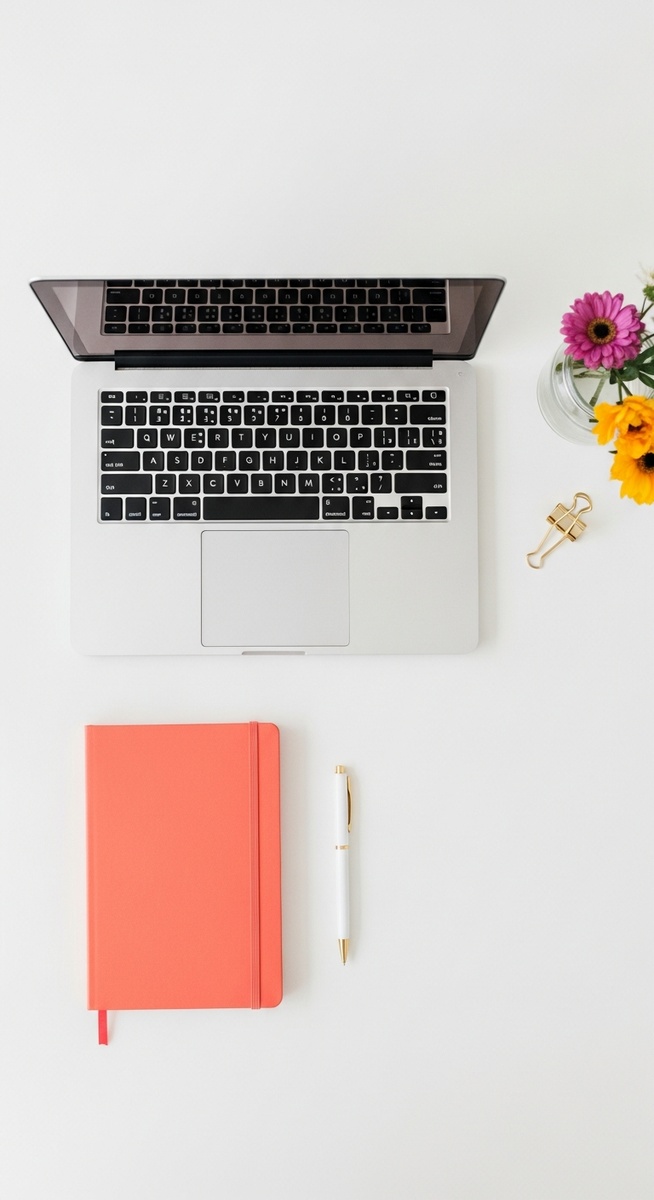 flatlay with laptop and other items on a white surface