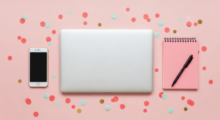 pink flatlay with laptop, notebook, and phone for someone researching which are the best income generating assets