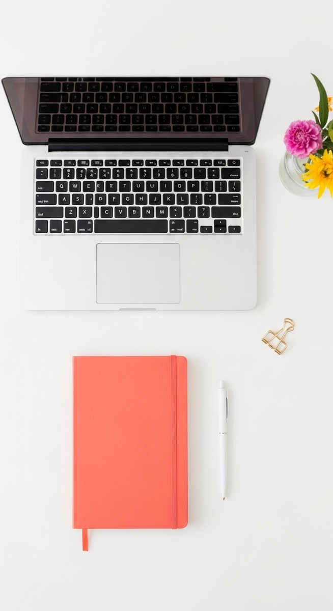 flatlay with laptop and other items on a white surface