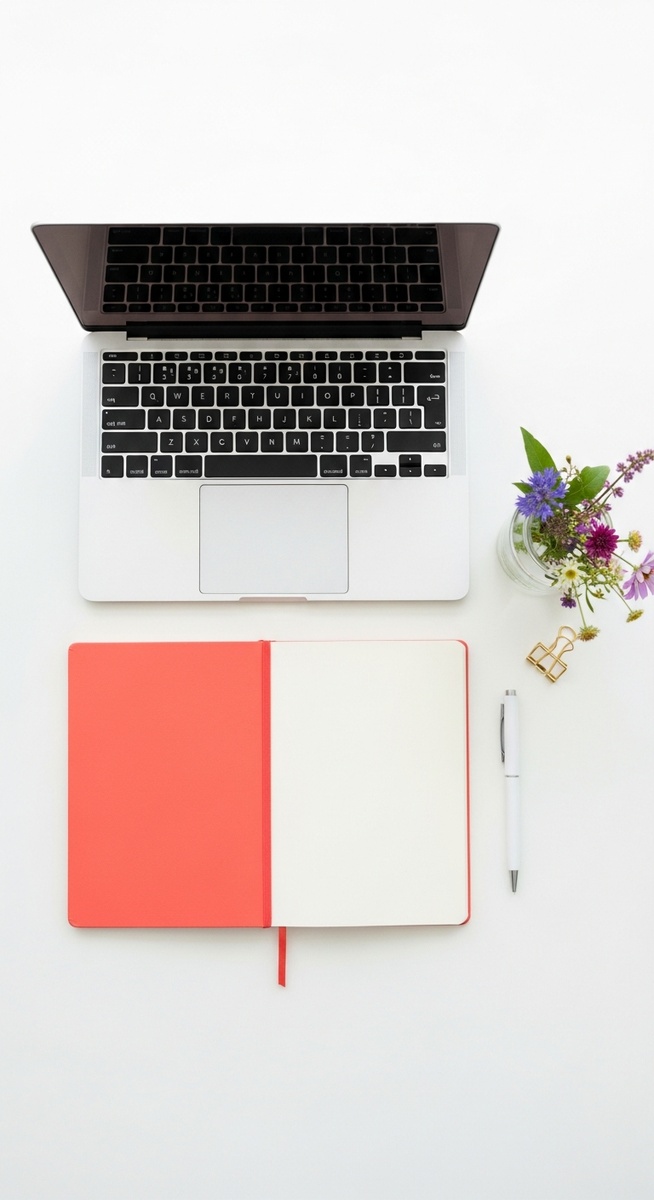flatlay with laptop and other items on a white surface