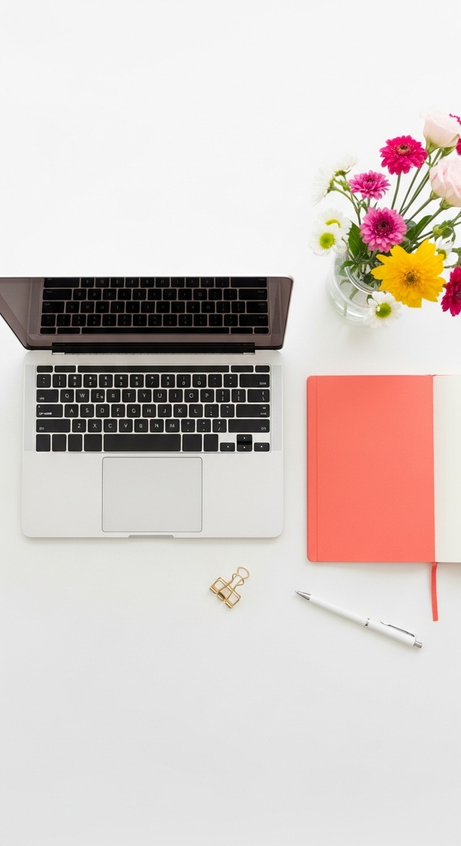 flatlay with laptop and other items on a white surface