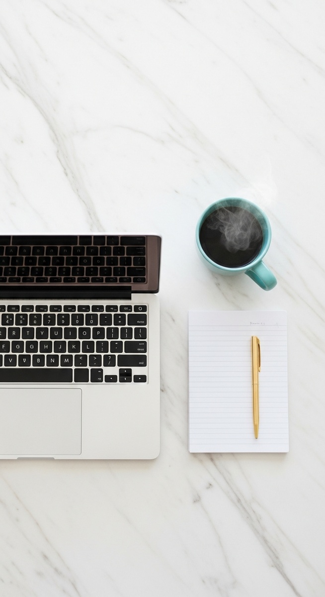 a flatlay of a laptop and teal mug on a marble surface to save $10,000