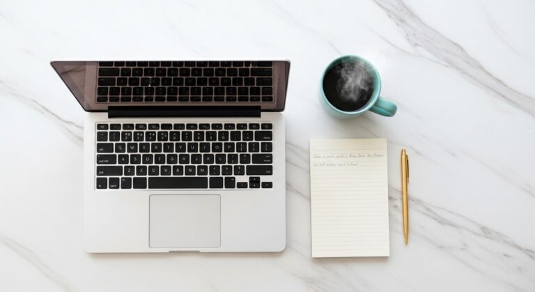 a flatlay of a laptop and teal mug on a marble surface to make an extra $500