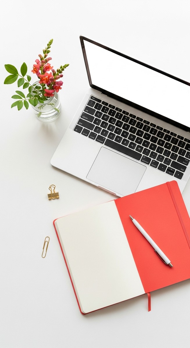 flatlay with laptop and other items on a white surface