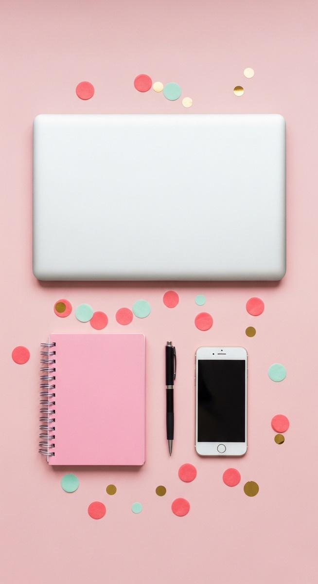 a pink flatlay with laptop, notebook, and phone to make money